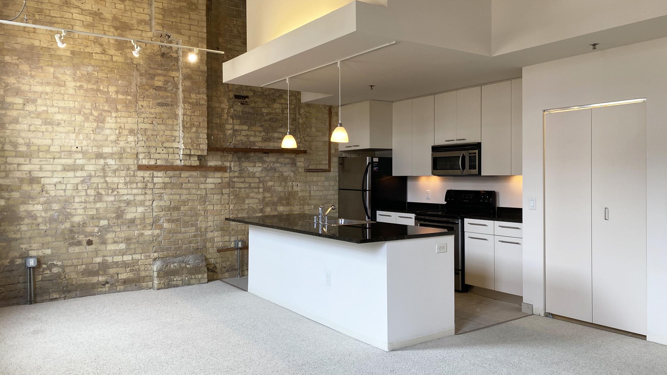 Tobacco-Lofts-at-The-Yards-Apartment-E209-One-Bedroom-Historic-Exposed-Brick-Timber-Beams-Unique-Design-Cats-High-Ceiling-Balcony-Downtown-Madison-Fitness-Lounge-Courtyard