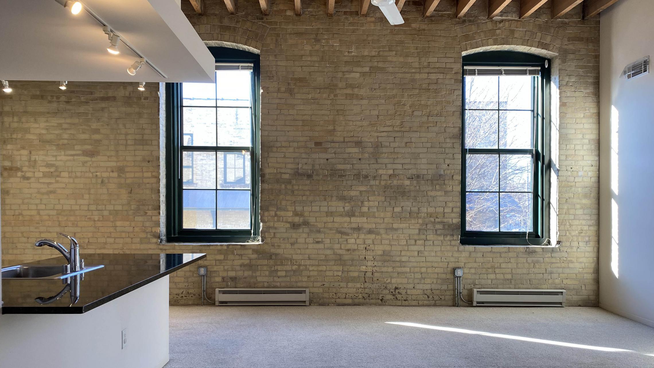 Tobacco-Lofts-at-The-Yards-Apartment-E212-Two-Bedroom-Balcony-Historic-Exposed-Brick-Timber-Beams-Unique-Design-Cats-High-Ceiling-Balcony-Downtown-Madison-Fitness-Lounge-Courtyard-Top-Floor-Vaulted-Ceiling