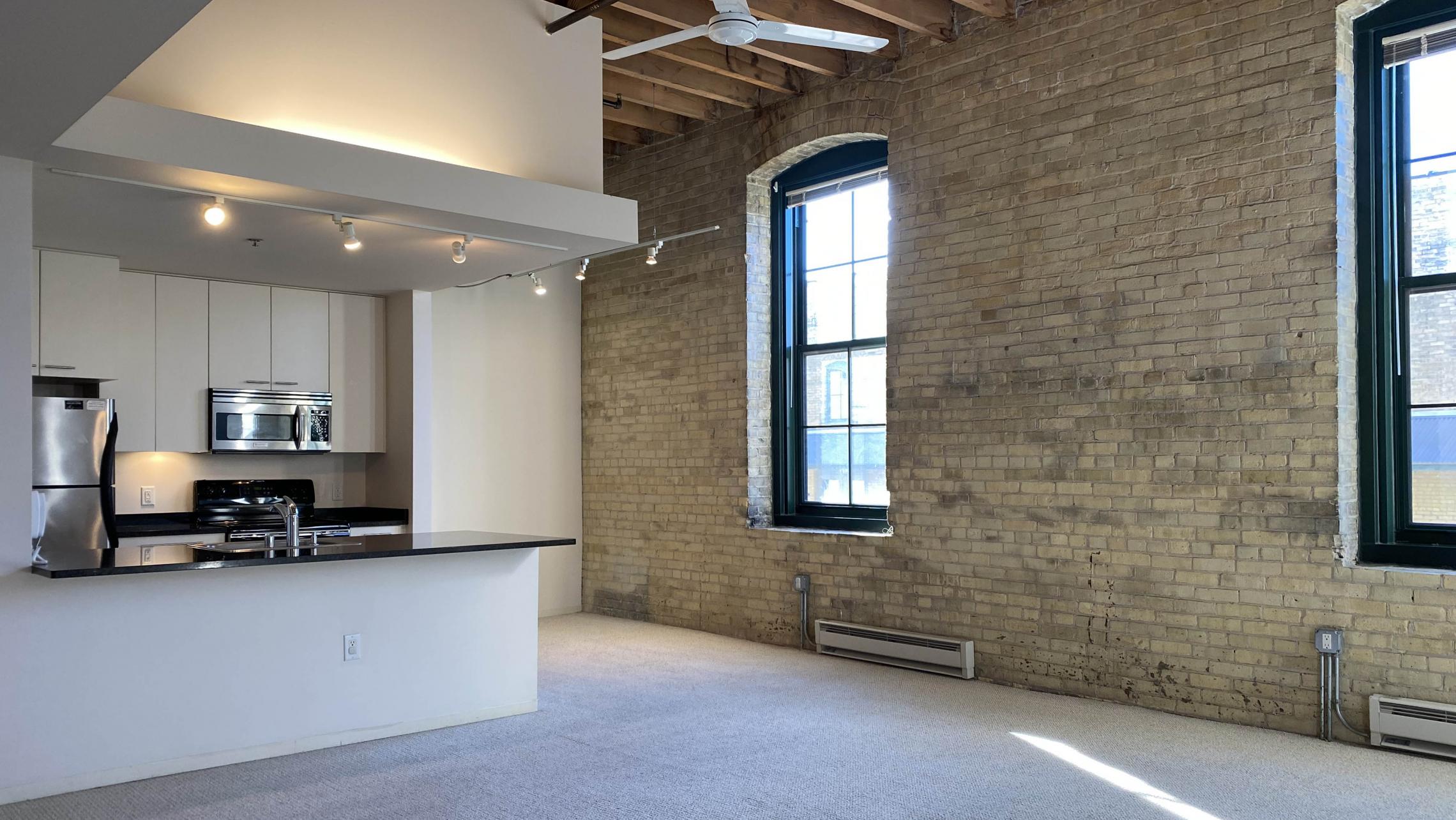 Tobacco-Lofts-at-The-Yards-Apartment-E212-Two-Bedroom-Balcony-Historic-Exposed-Brick-Timber-Beams-Unique-Design-Cats-High-Ceiling-Balcony-Downtown-Madison-Fitness-Lounge-Courtyard-Top-Floor-Vaulted-Ceiling