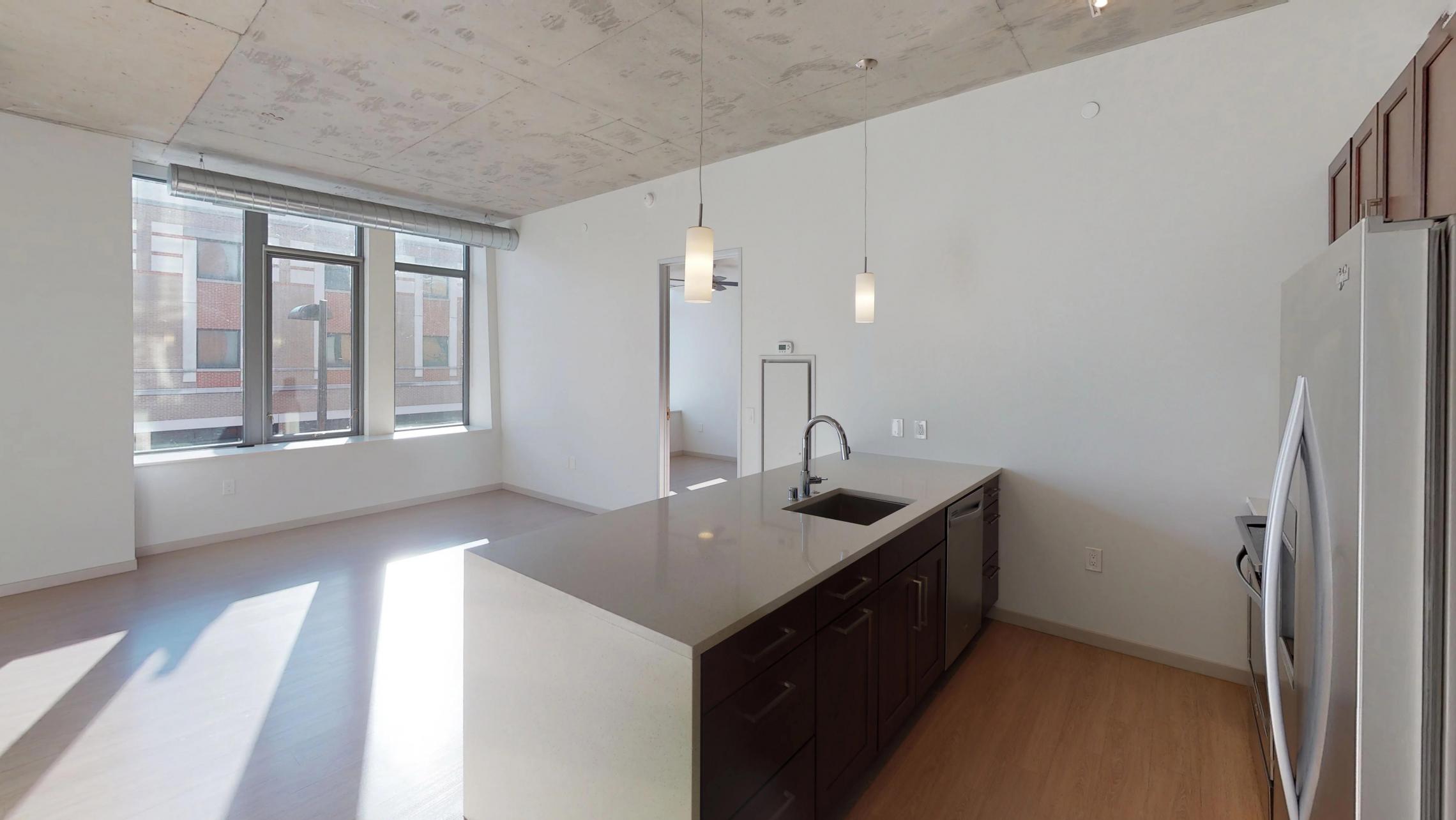 Pressman-211-Apartment-One-Bedroom-Luxury-Modern-Upscale-Downtown-Capitol-Concrete-Madison-Kitchen-Island-Living-Space-Sunny-Natural-Light