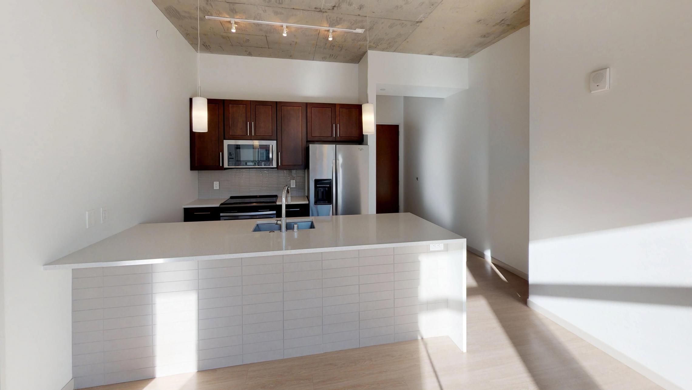 Pressman-311-Apartment-One-Bedroom-Luxury-Modern-Upscale-Downtown-Capitol-Concrete-Madison-Kitchen-Island-Living-Room-Sunny-Bright.jpg