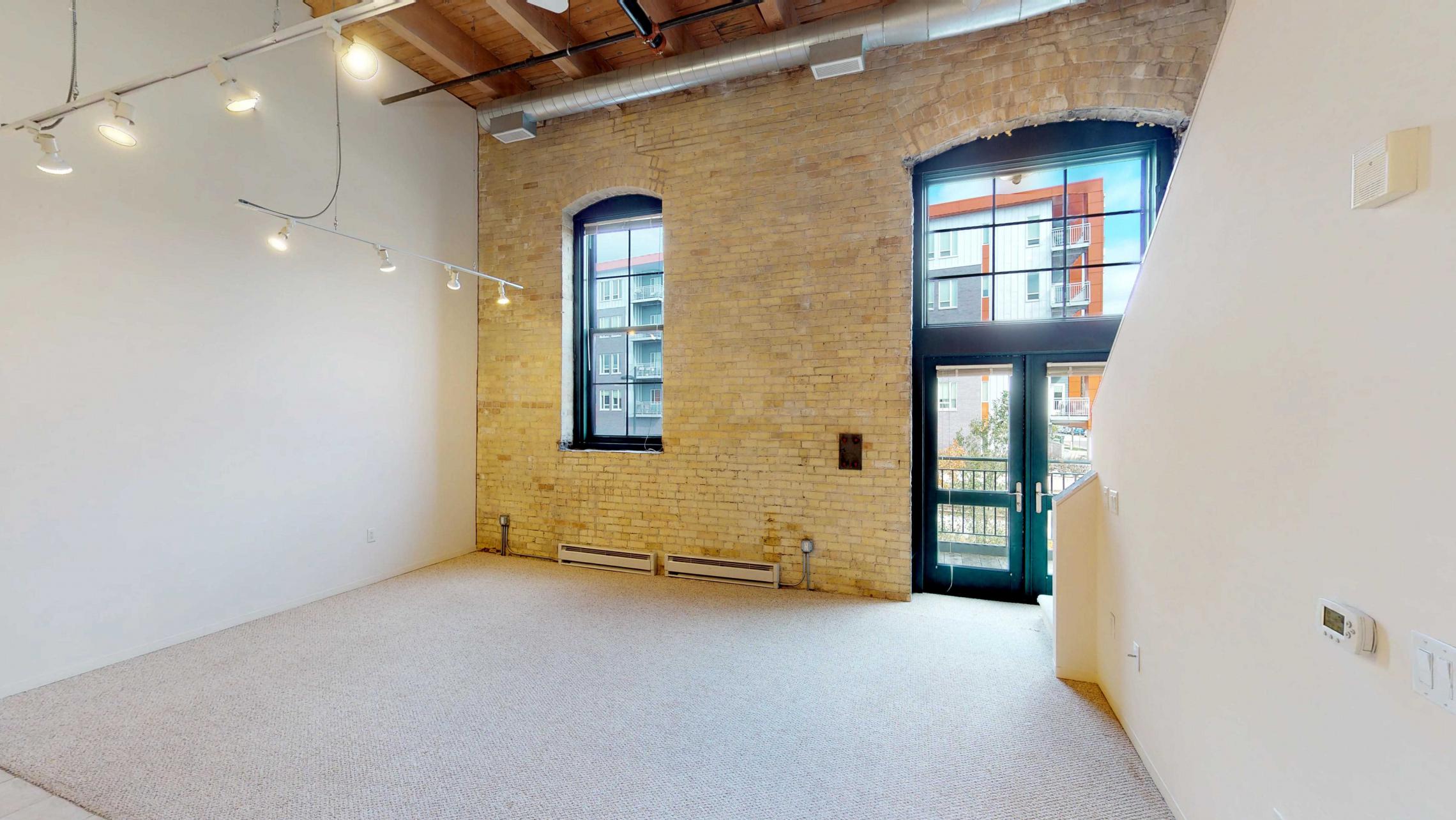 Tobacco-Lofts-E203-Two-bedroom-historic-design-upscale-exposed-brick-downtown-balcony-lake-view.jpg