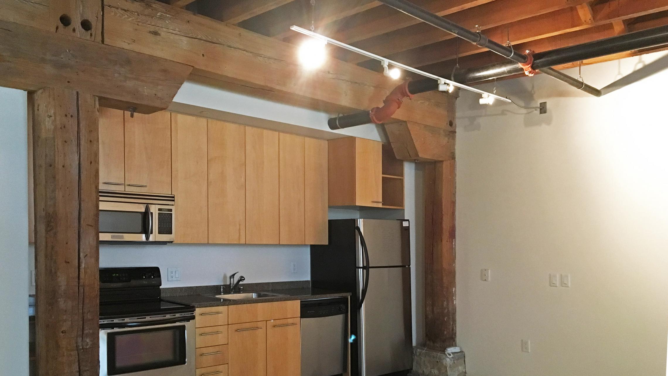 ULI Tobacco Lofts - E111 - Kitchen with Historic Wood Beams